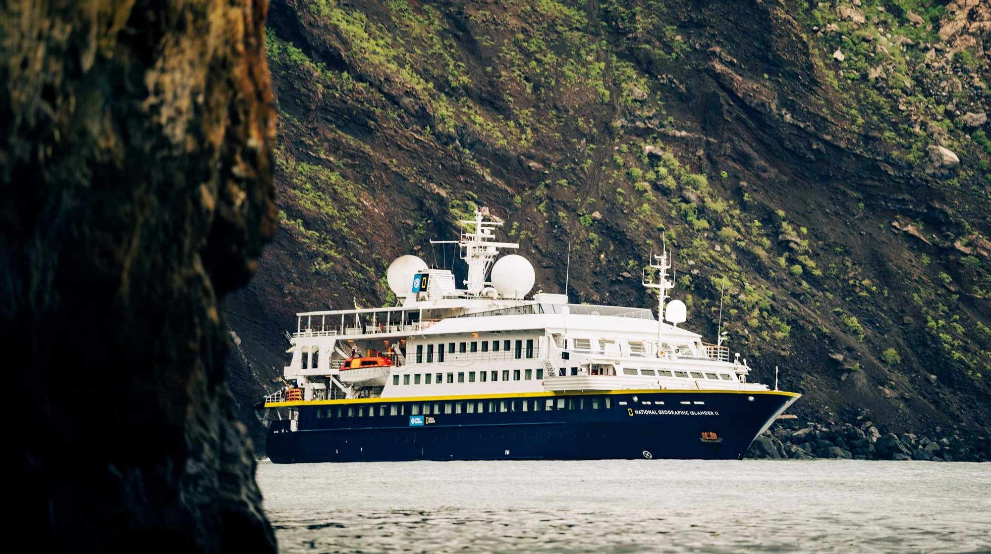 The National Geographic Islander II expedition cruise ship sails through the Galapagos