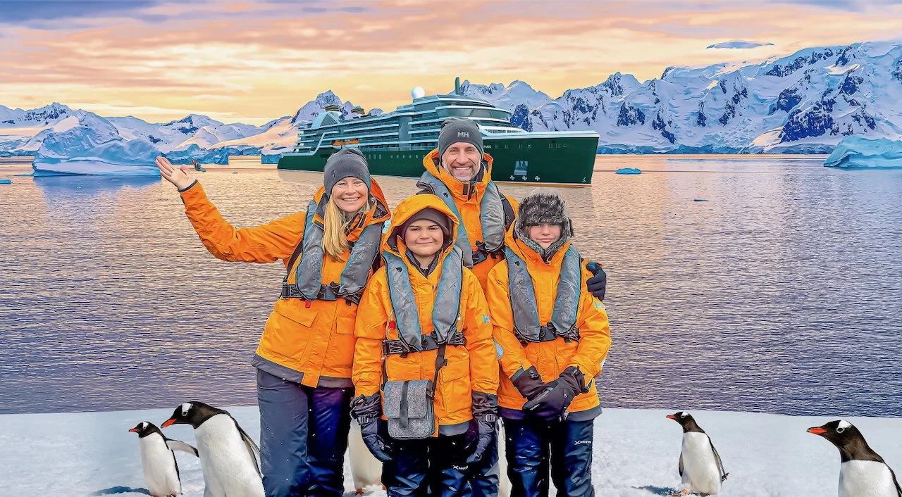 The Lockwood family standing in Antarctica with a cruise ship behind