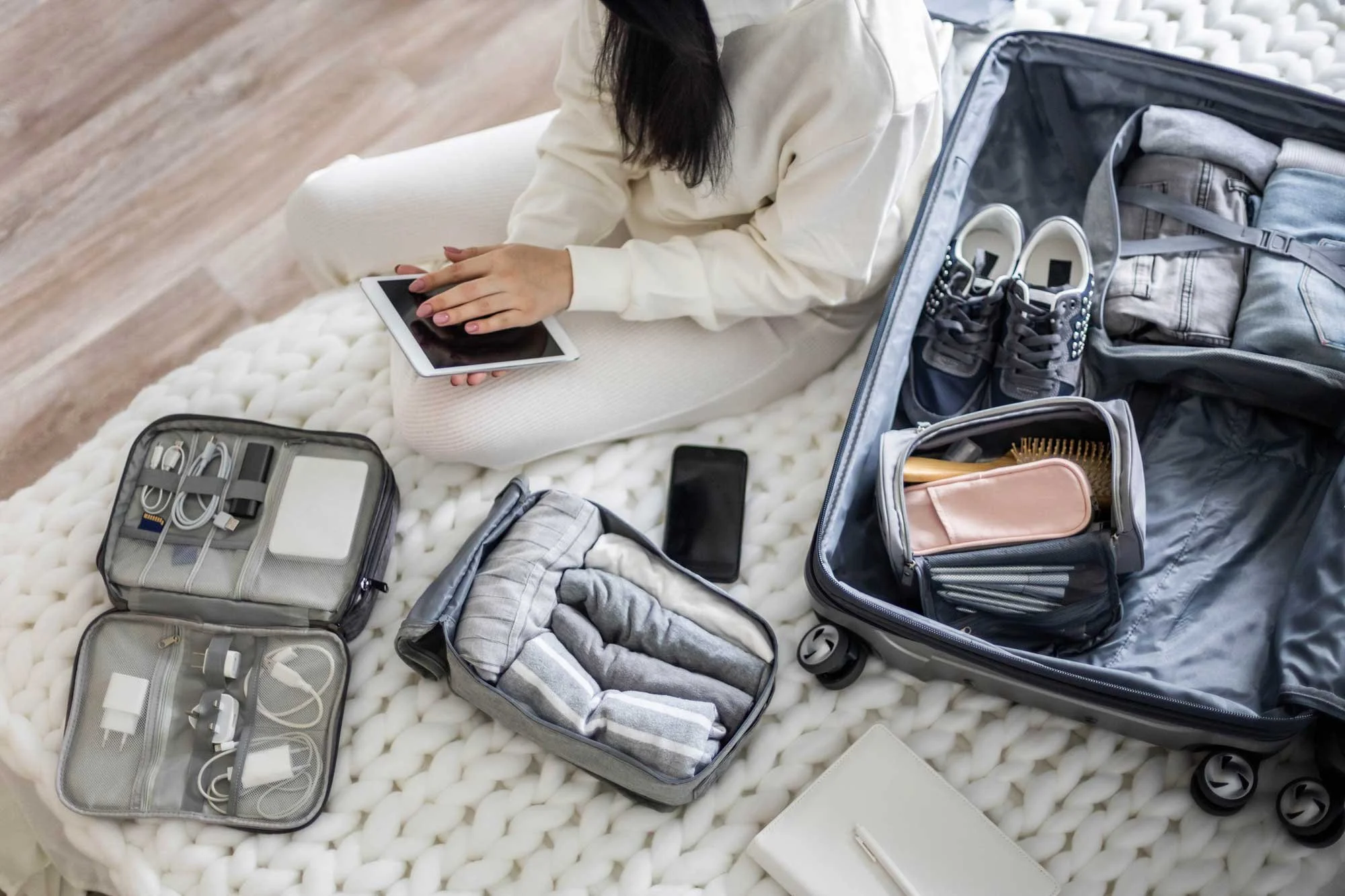 A woman packs for a trip