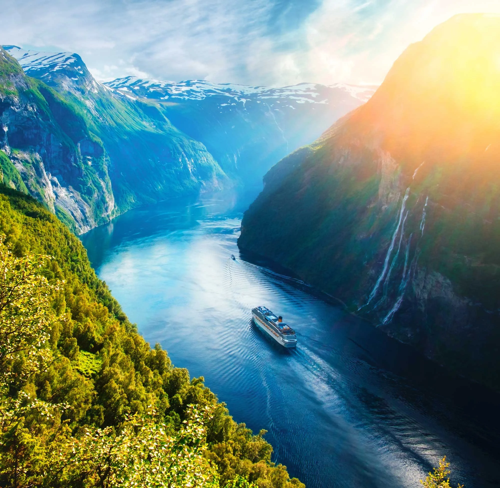 A cruise ship sails through fjords of Norway