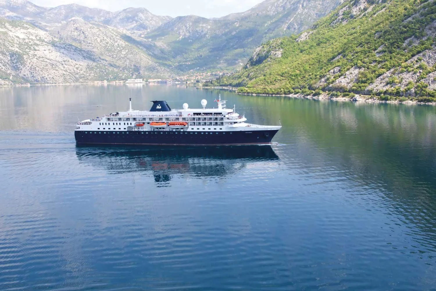 A Swan Hellenic expedition cruise ship in a fjord