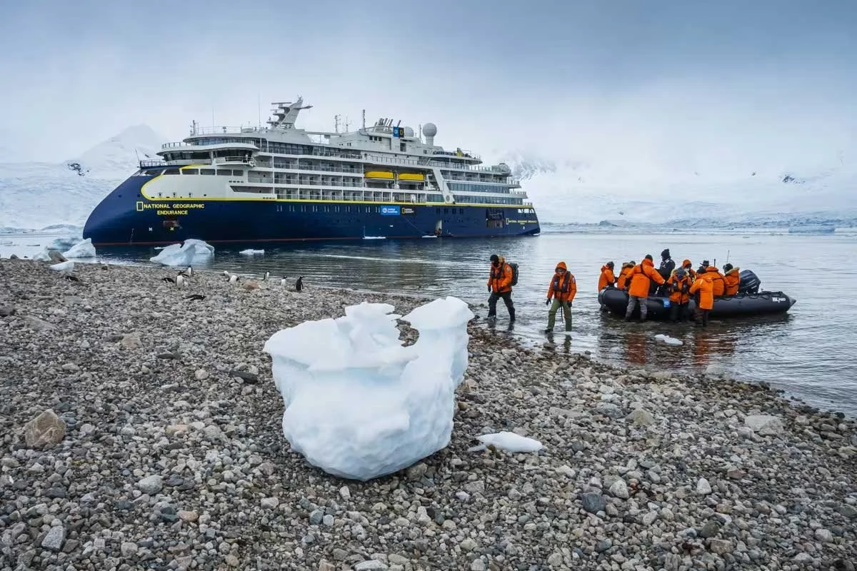 A National Geographic expedition cruise ship offloads a zodiac of passengers