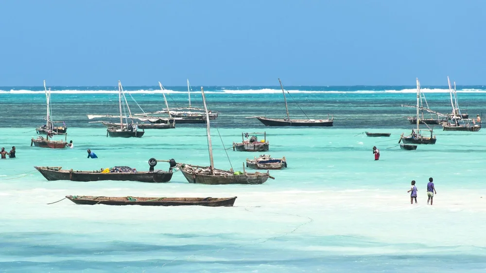 Boats sit in a bay in turquoise water