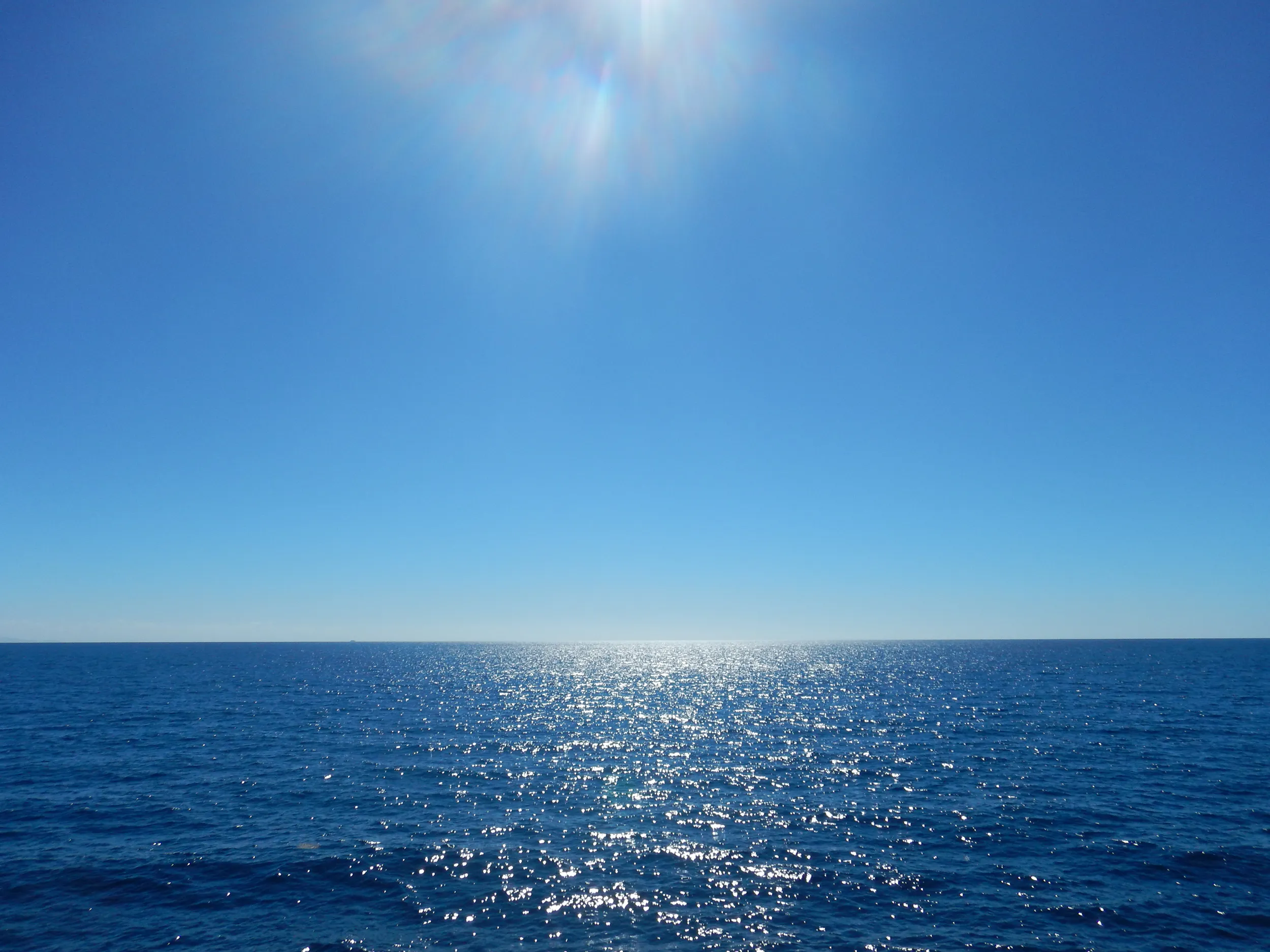The sun shines down onto blue waters of the Pacific Ocean