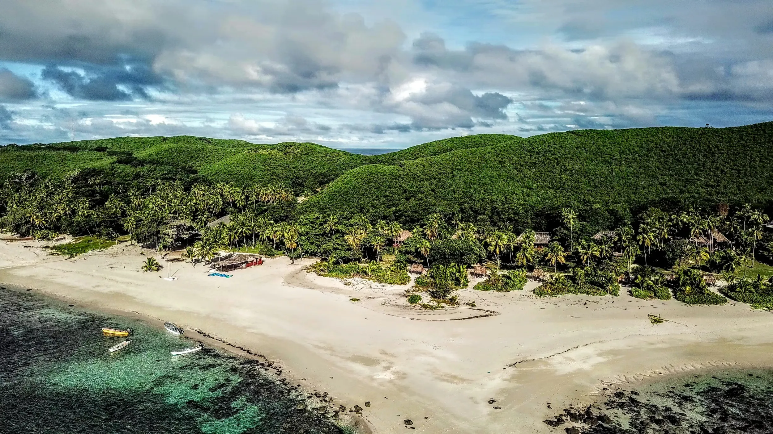 Aerial view of a beach and village in Fiji
