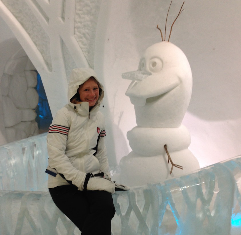 Erin Lockwood sits with a snowman at Hotel de Glace