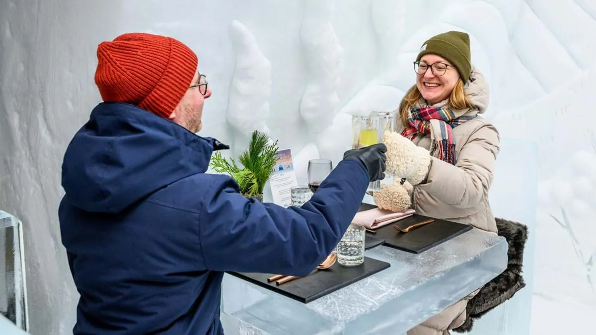 A couple toasts drinks at Hôtel de Glace