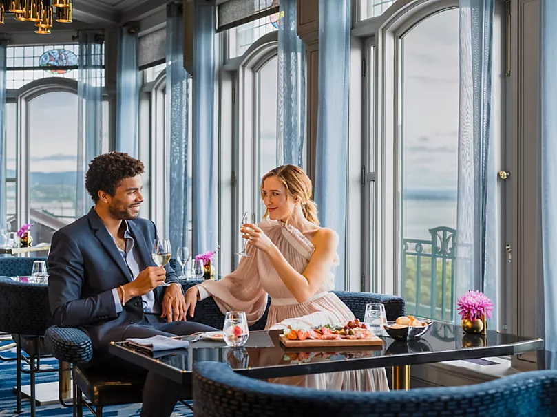 A couple dines at a restaurant in Fairmont Le Château Frontenac