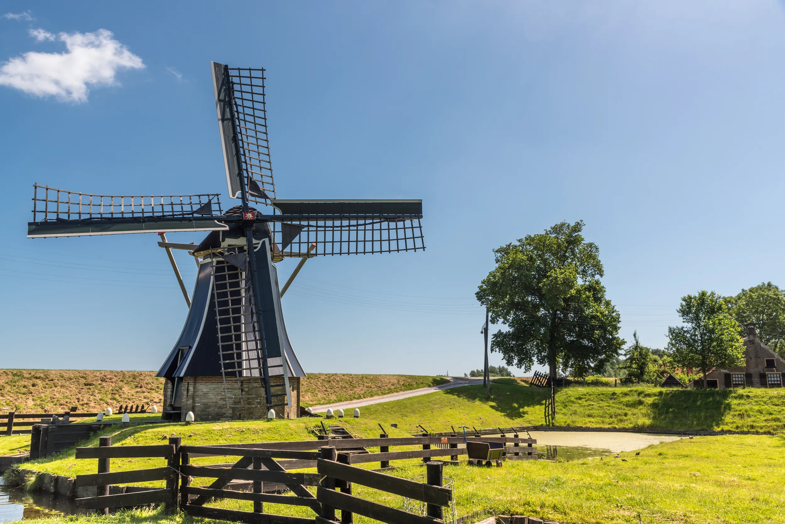 A lone windmill in a field