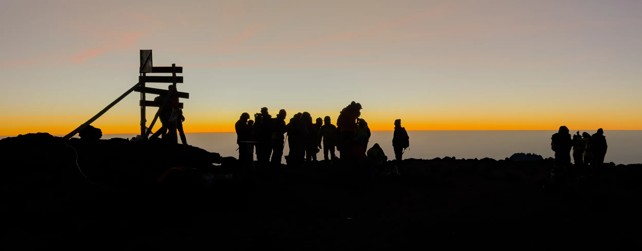 A group of hikers on the summit of Kilimanjaro