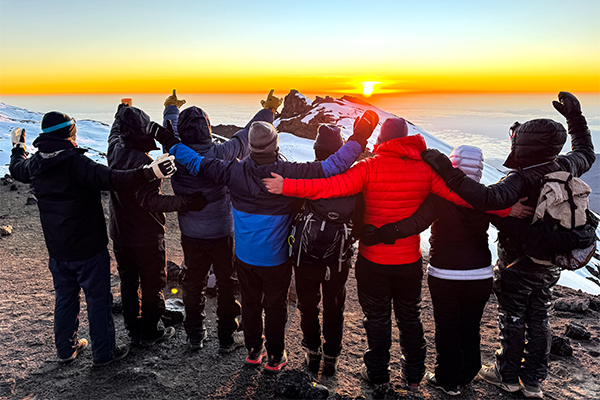 Hikers pose at the summit on Kilimanjaro