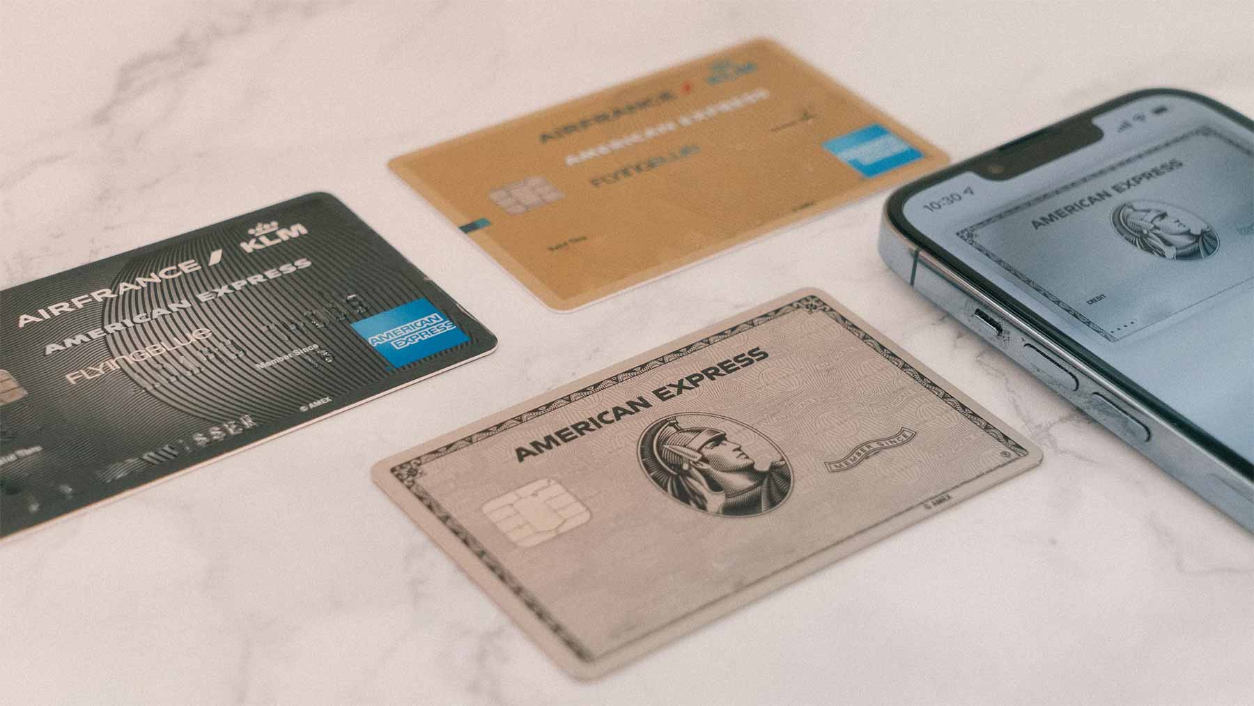 Credit cards fanned out on a table next to a smartphone
