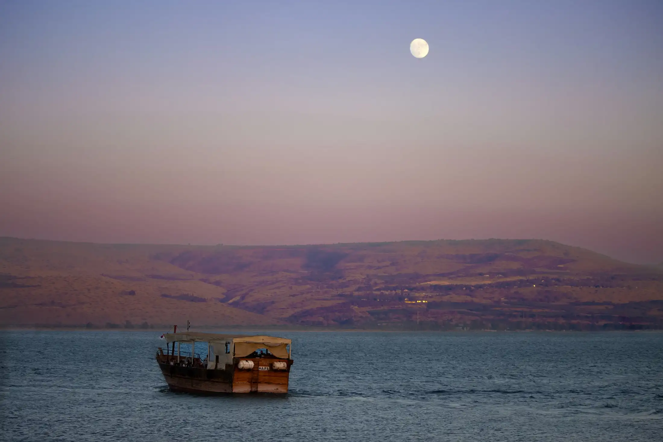 A boat on the Sea of Galilee at sunset
