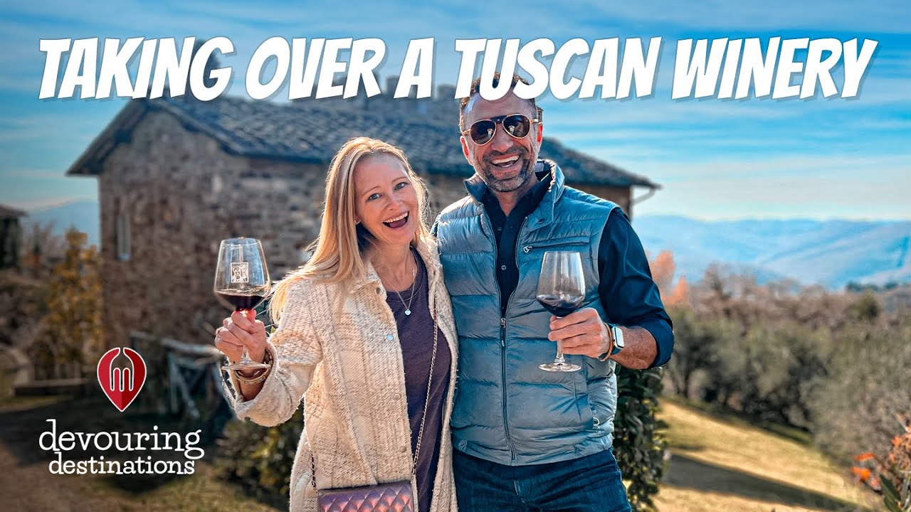 Erin and Phil Lockwood raising wine glasses at a Tuscan winery