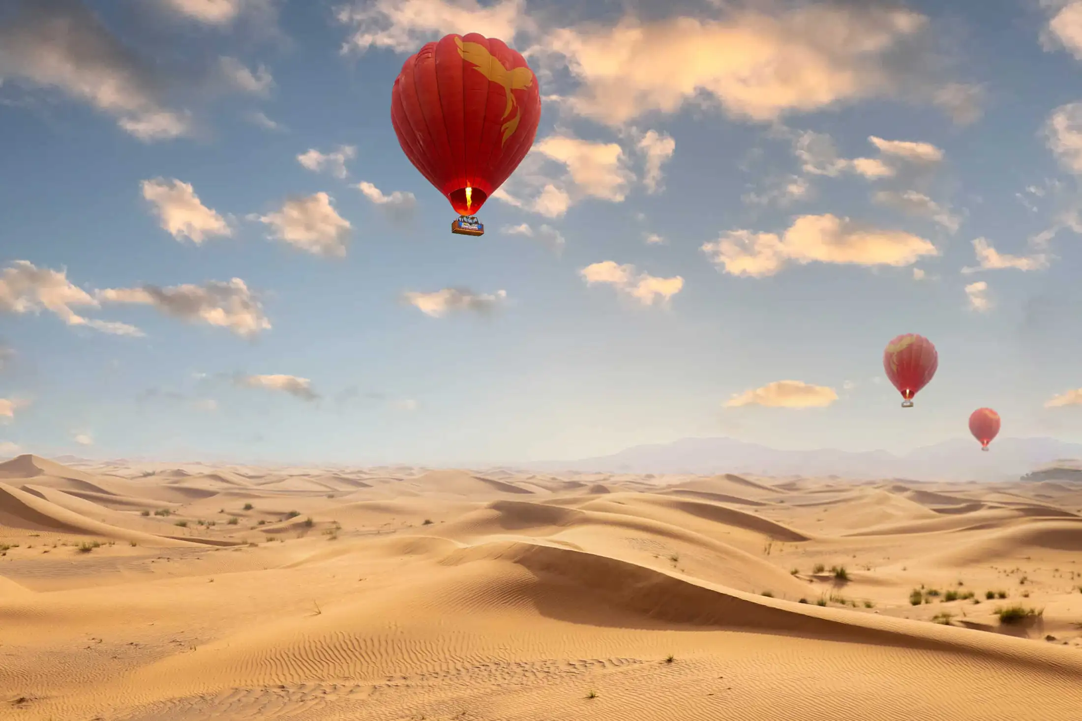 Hot air balloons sail above the sands of the UAE