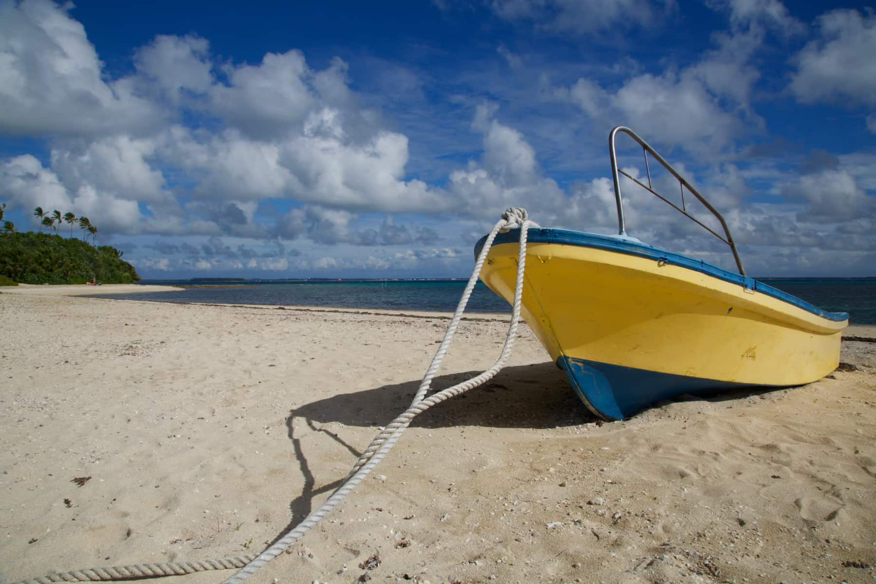 A small boat on a sandy beach in Tonga