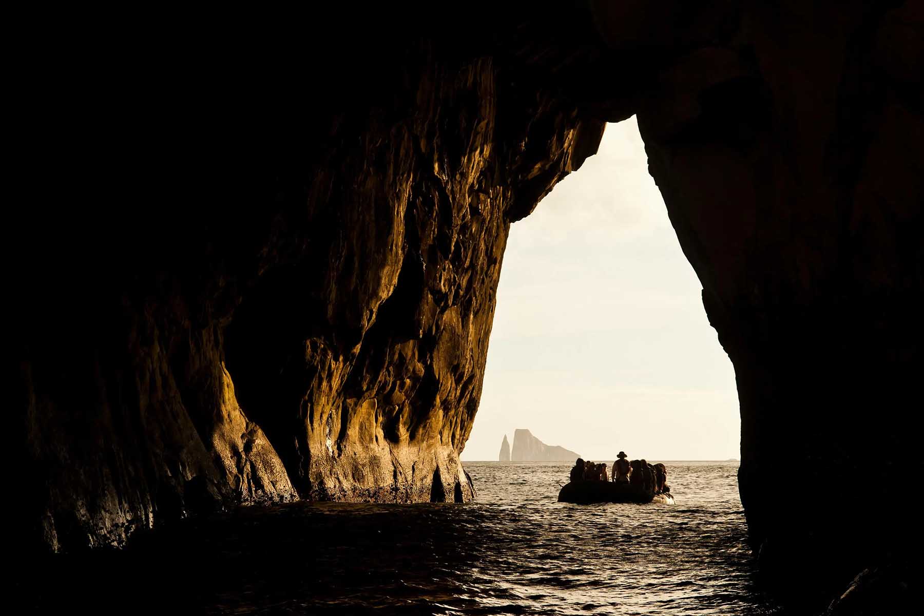 A Zodiac passes through Kicker Rock in the Galápagos Islands
