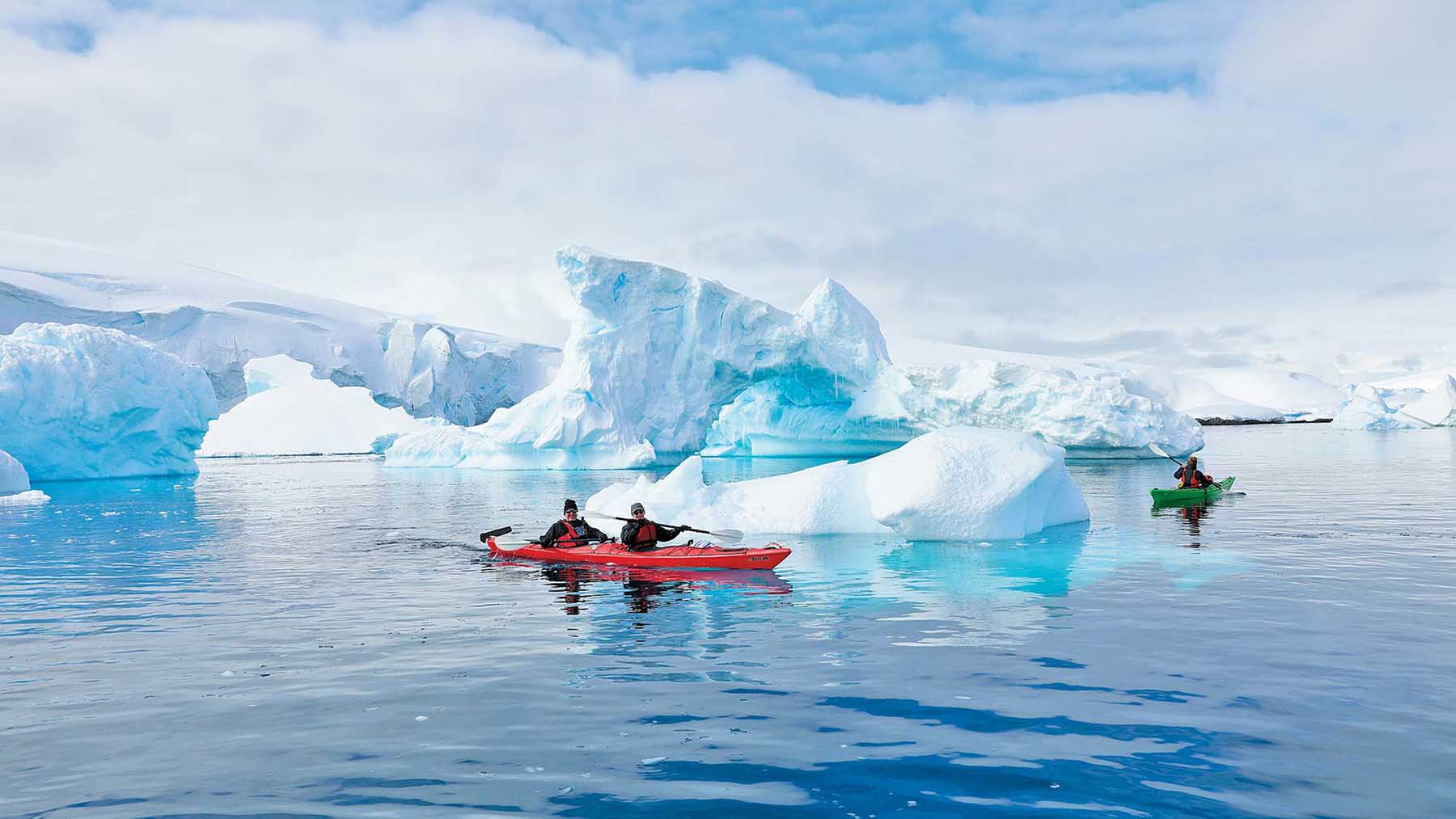 Kayakers explore icebergs in Antarctica