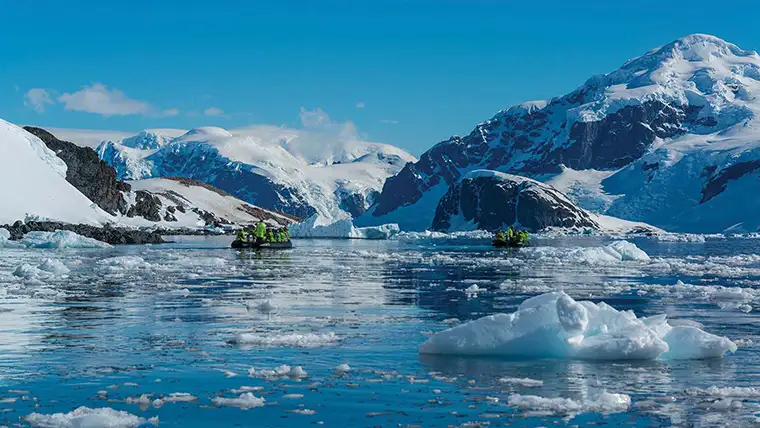 A zodiac navigates ice fields in Antarctica