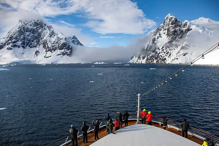 The bow of a cruise ship navigating Lamaire Channel in Antarctica