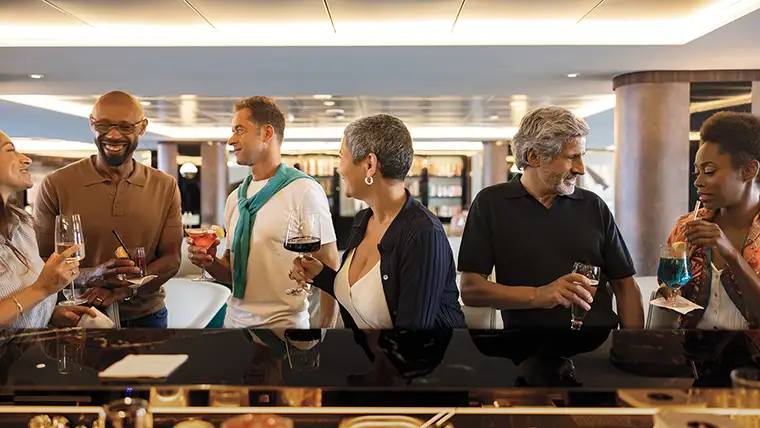 People gather at a bar on the Atlas World Navigator