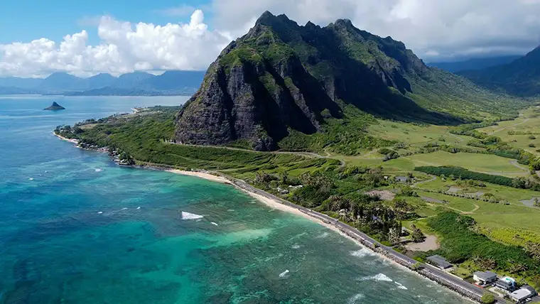 Aerial of Kualoa Ranch oceanfront and mountains