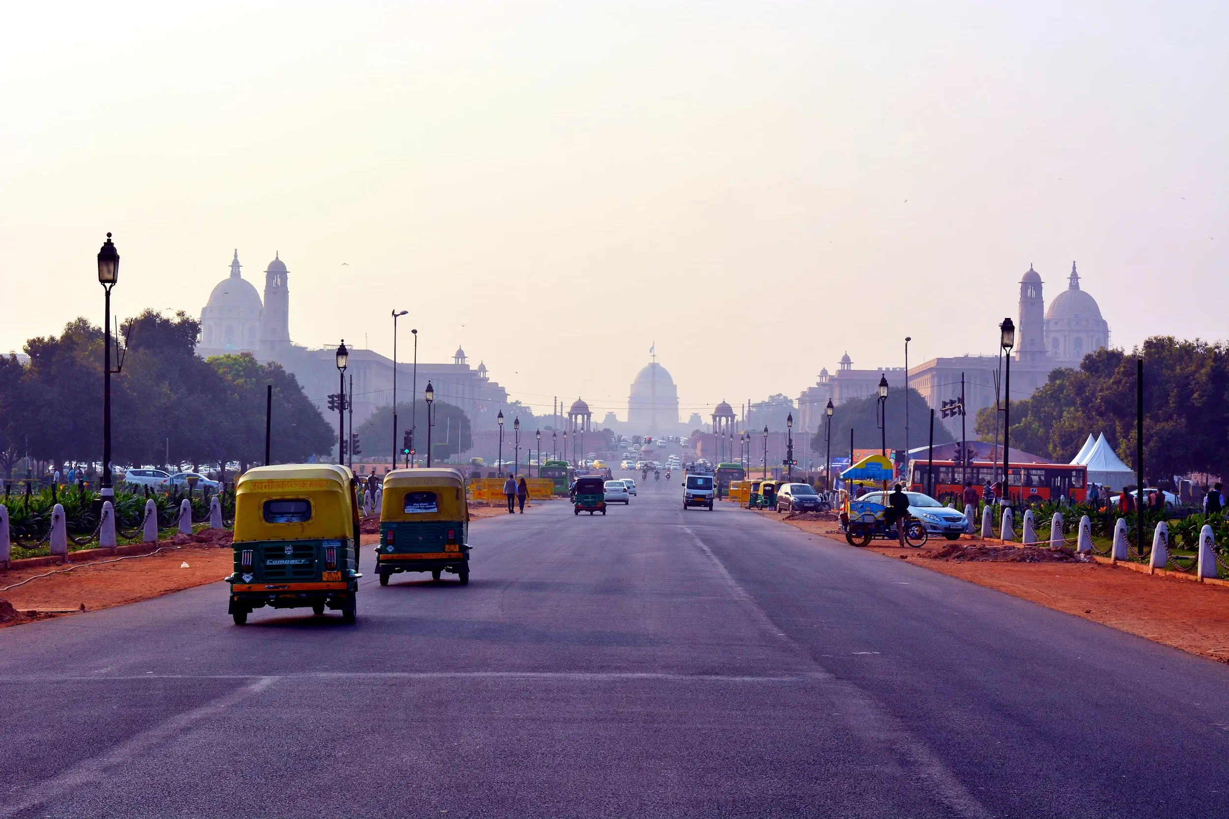 Trikes driving down a street in Delhi