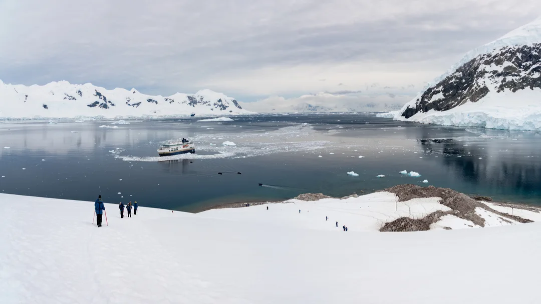 An HX Expeditions cruise ship sits in Niko Harbor Antarctica