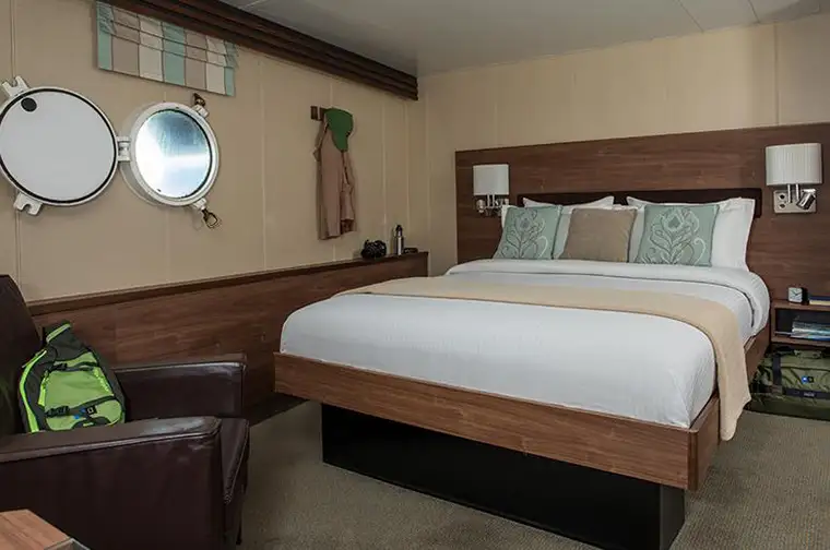 National Geographic Explorer Category 1 cabin interior with porthole windows on Main Deck
