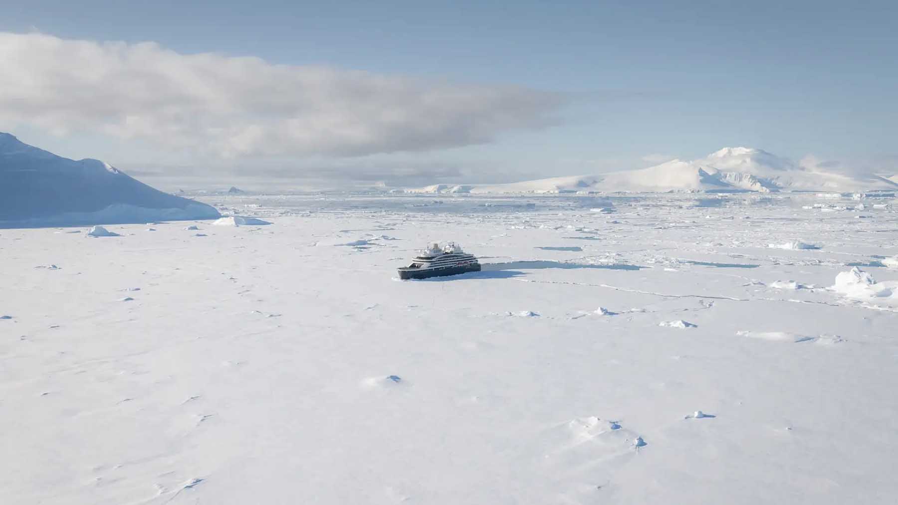 Le Commandant Charcot nuclear icebreaker cutting through polar ice aerial view