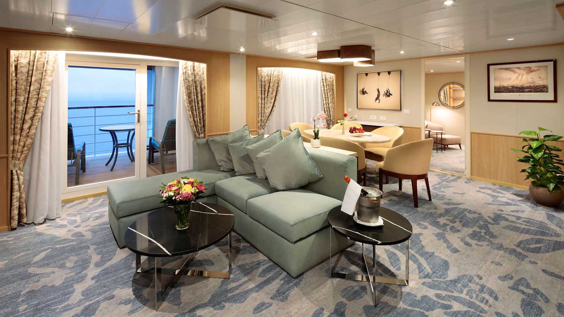 Suite living room aboard Windstar Star Breeze with ocean-facing seating