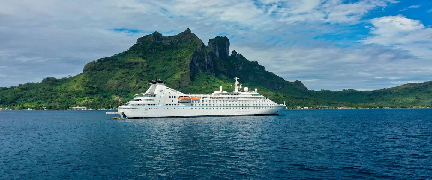 Windstar Star Breeze anchored in a pristine Tahitian bay, side view