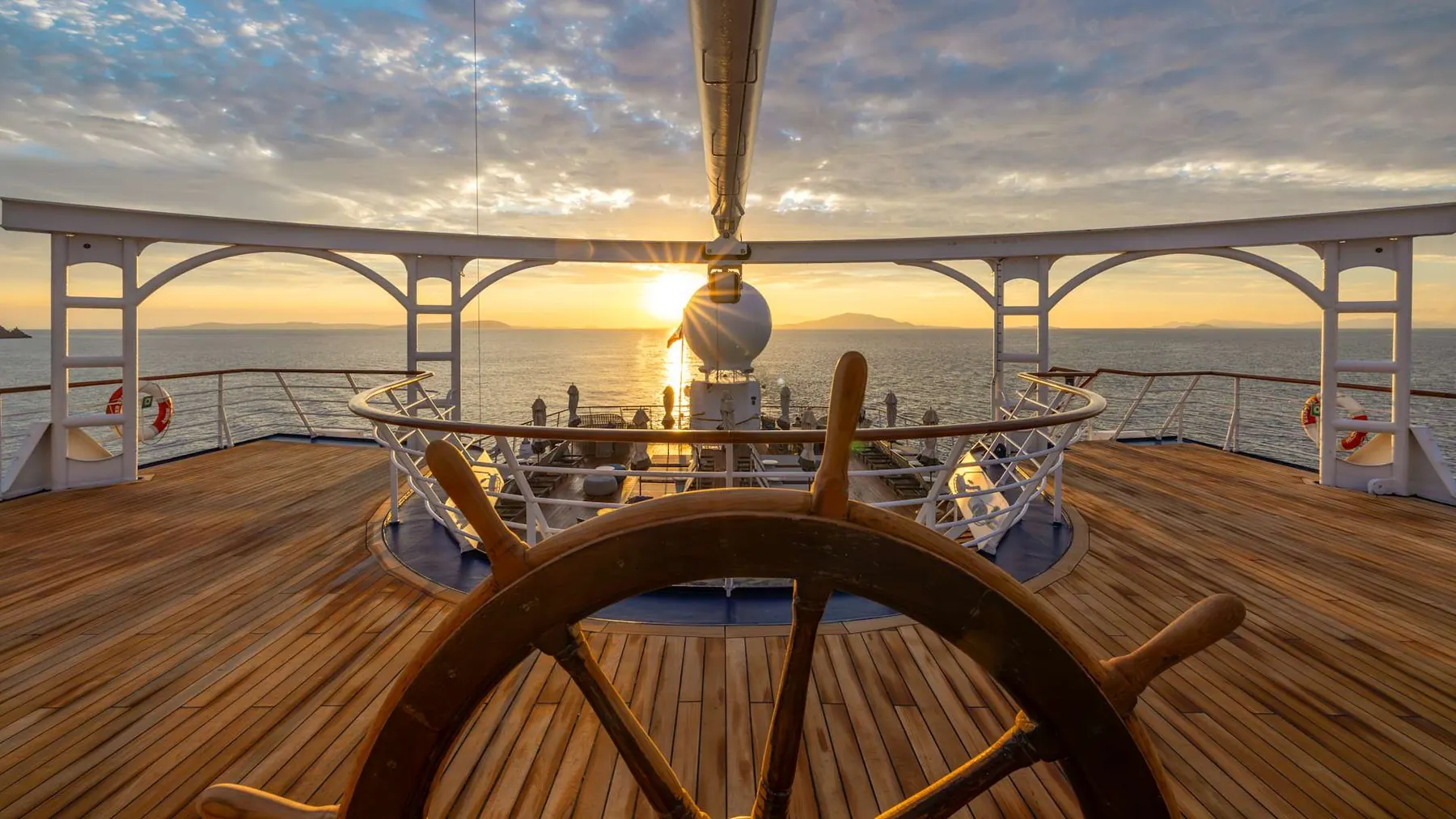Windstar Star Breeze bow deck at sunset with calm ocean horizon