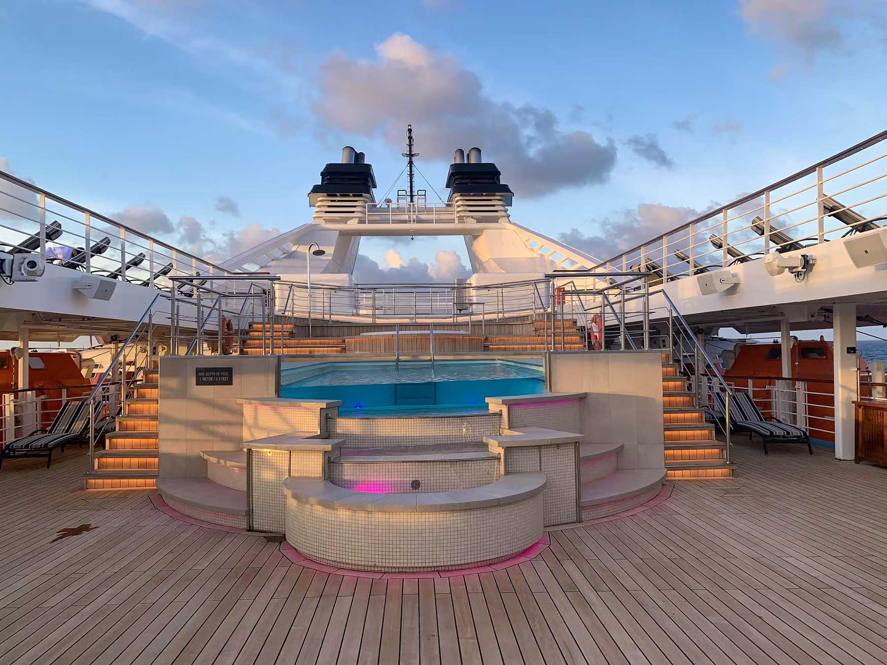 Pool deck on Windstar Star Breeze with sun loungers and ocean views