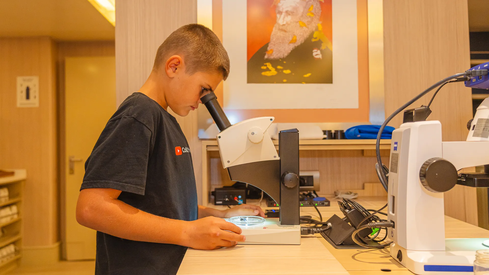Colt Lockwood looks into a microscope on the MS Santa Cruz II Galapagos cruise ship