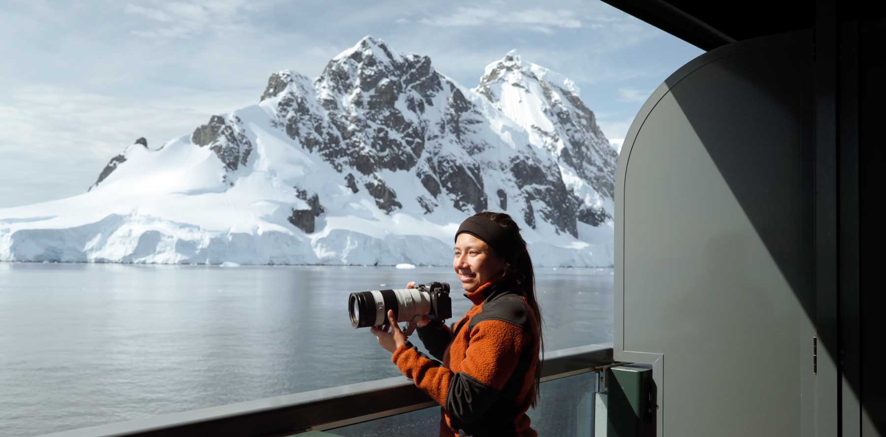 Sarah Rodgers standing on a veranda on a cruise ship in Antarctica