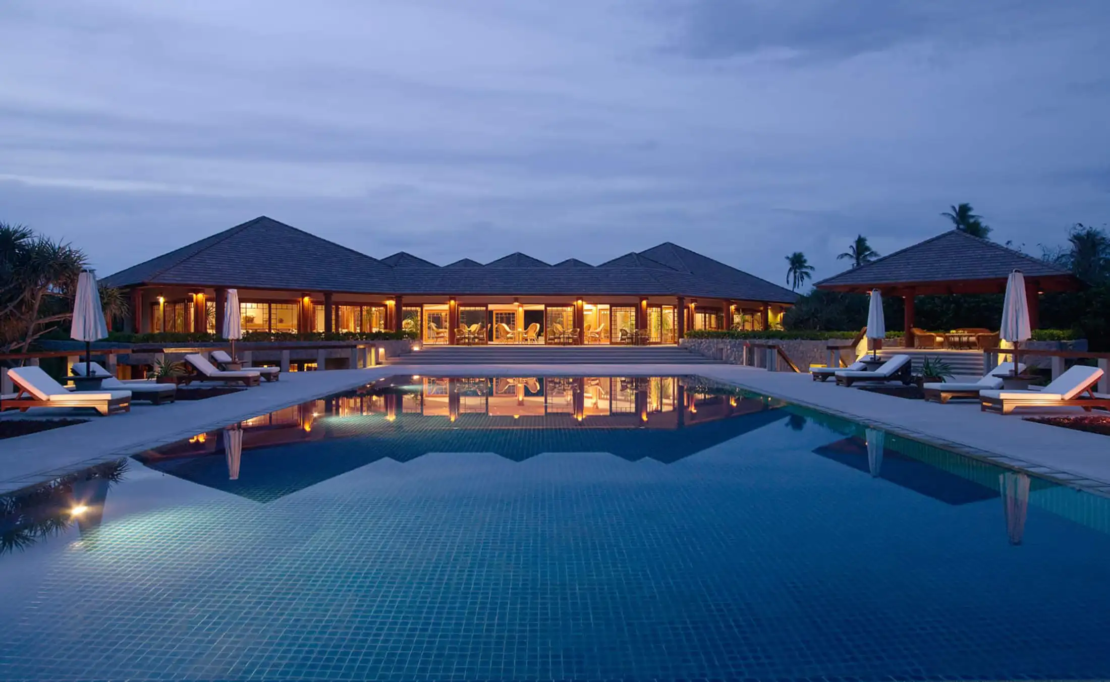 Amanpulo resort pool at dusk