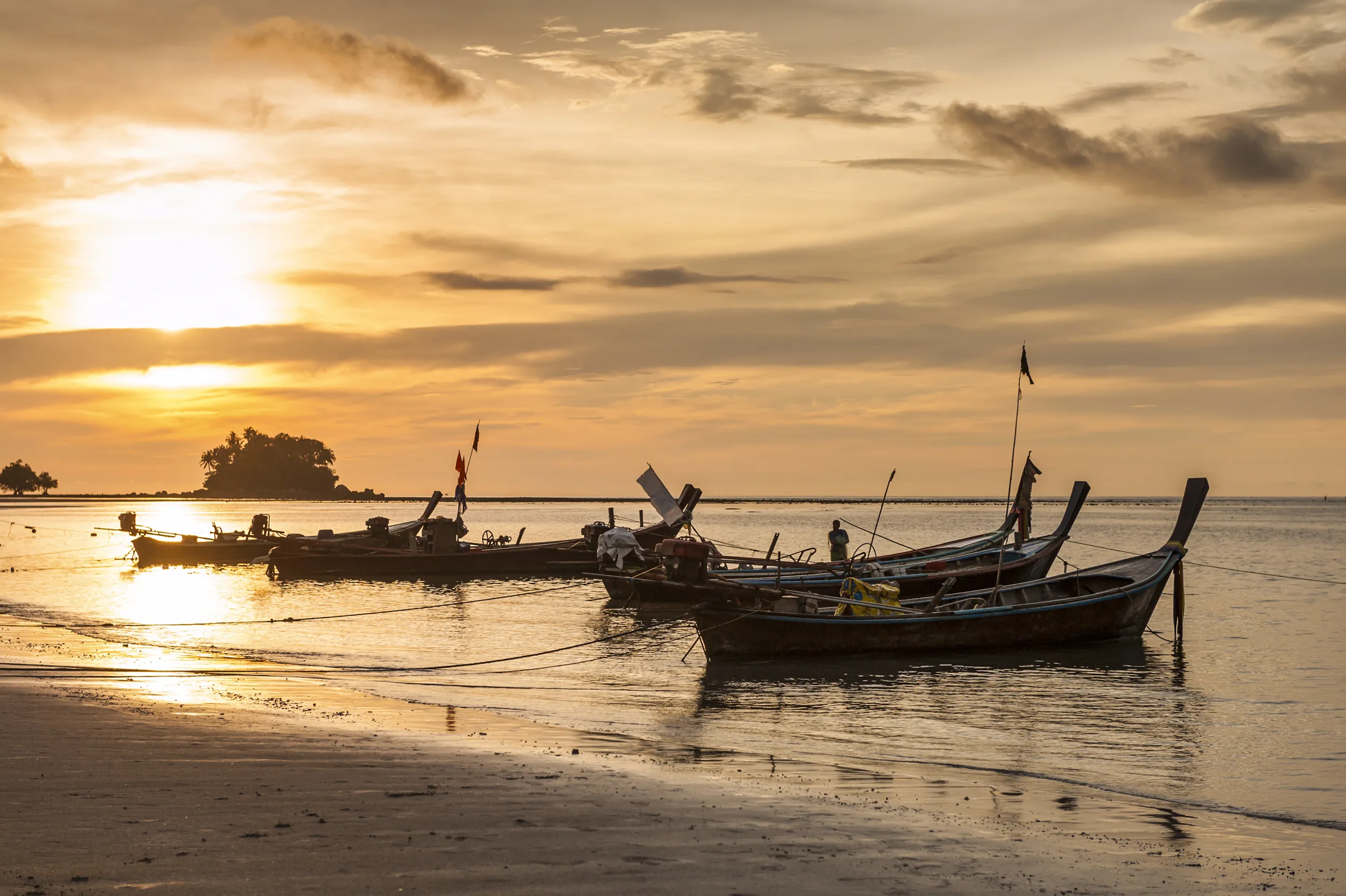 Nai yang boats on a sunset beach in Phuket