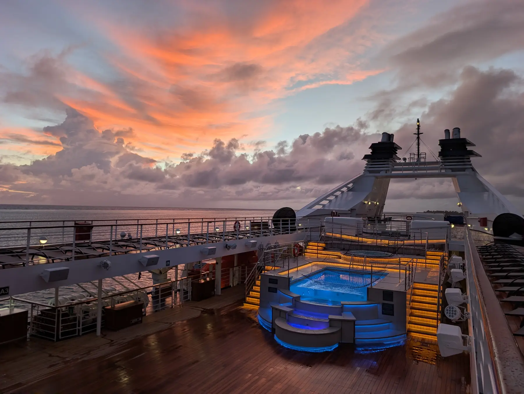Pool deck on Windstar Star Breeze with sun loungers and ocean views