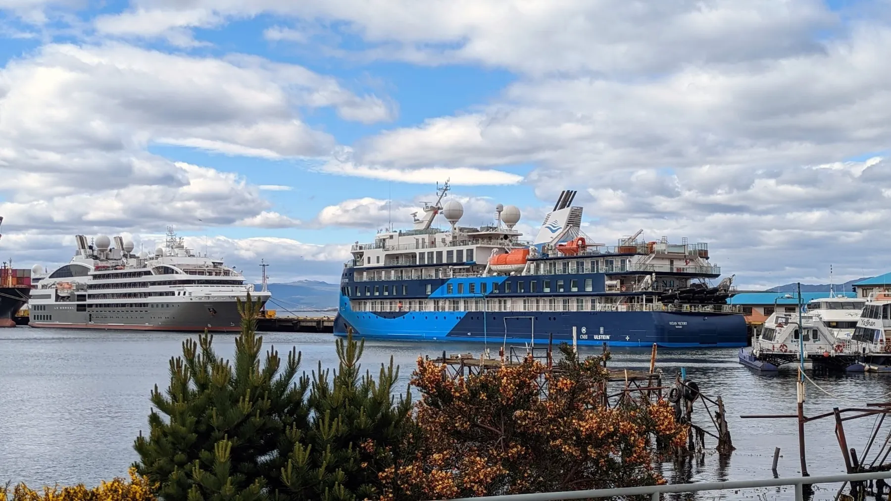 Two expedition cruise ships sit in a port in Ushuaia