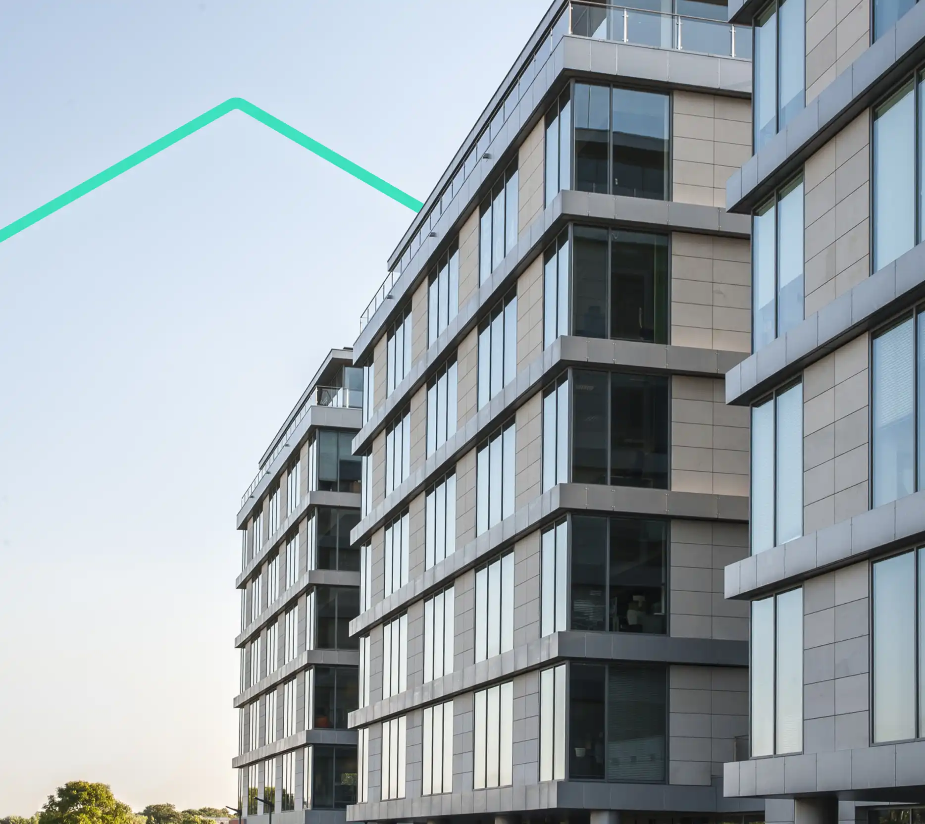 Modern apartment buildings with large glass windows under a clear sky.