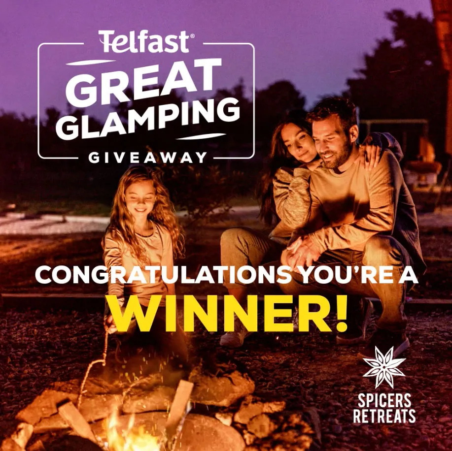 Family enjoying a campfire at night with text announcing Telfast Great Glamping Giveaway winner and Spicers Retreats logo.