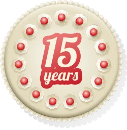 Round cream cake decorated with red dots and text reading '15 years' in the center.