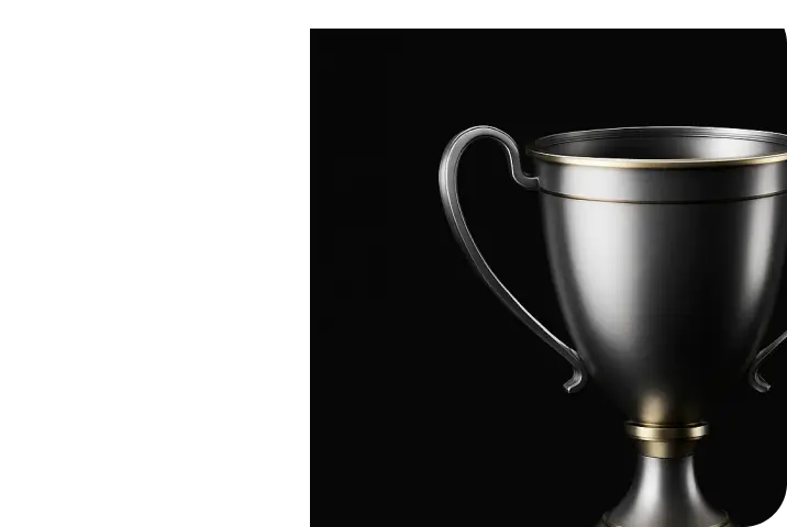 Close-up of a sleek black and gold trophy cup with two handles on a black background.