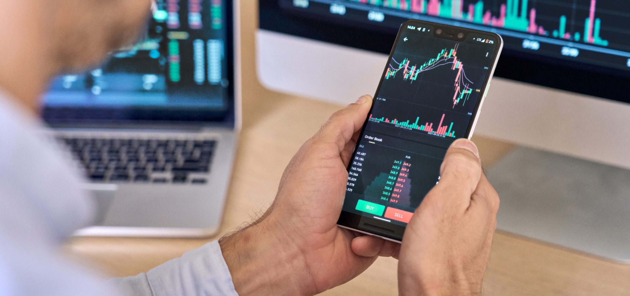 man trading on a phone - Can You Start Day Trading With $100