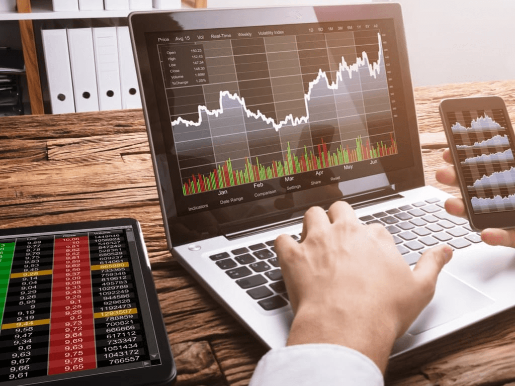 man trading on his laptop - Options vs Margin Trading