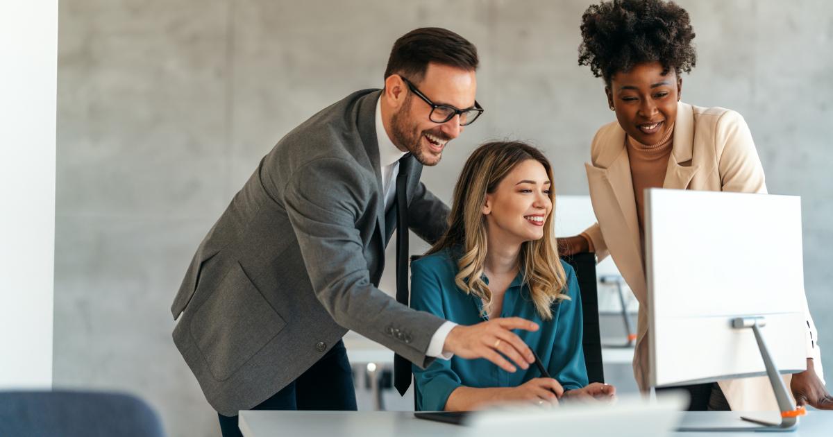 employees laughing - Crypto Prop Trading Firms List