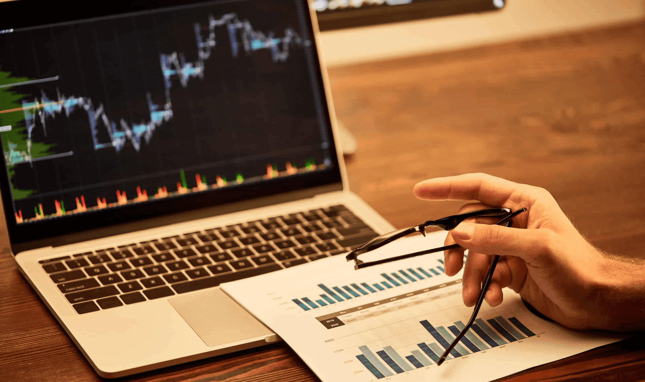 Person analyzing financial data on laptop - Best Free Paper Trading Platform