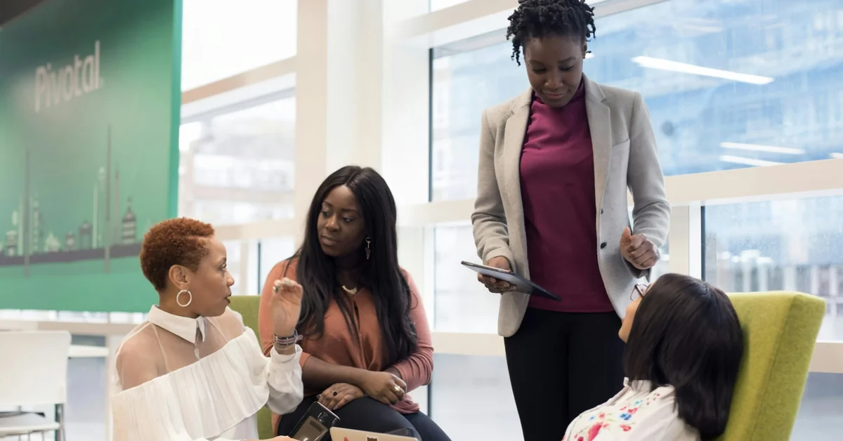 Group of professional women in office meeting with tablet — how prop firms make money