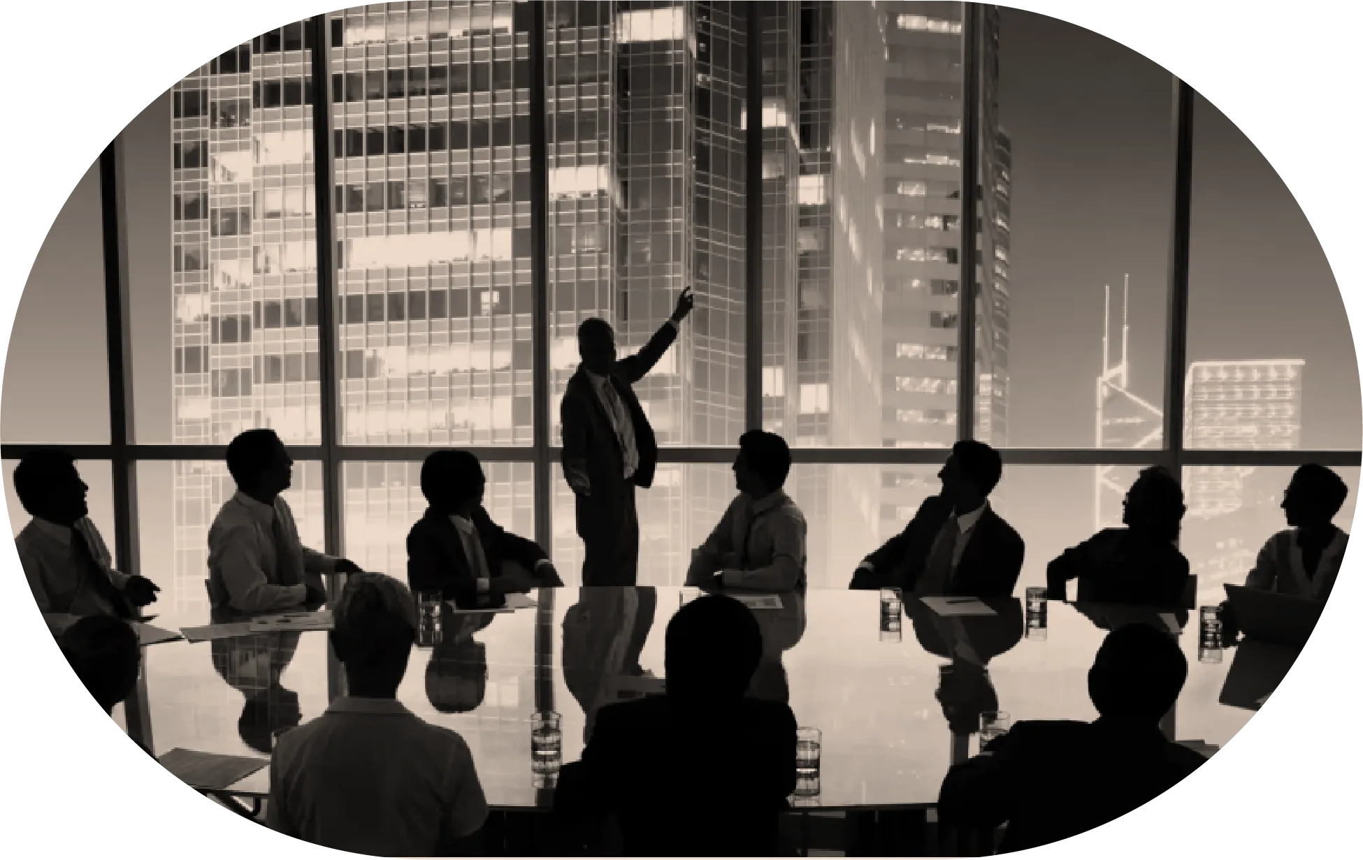 Silhouettes of business people in a meeting room with one standing and pointing at a window showing city buildings.